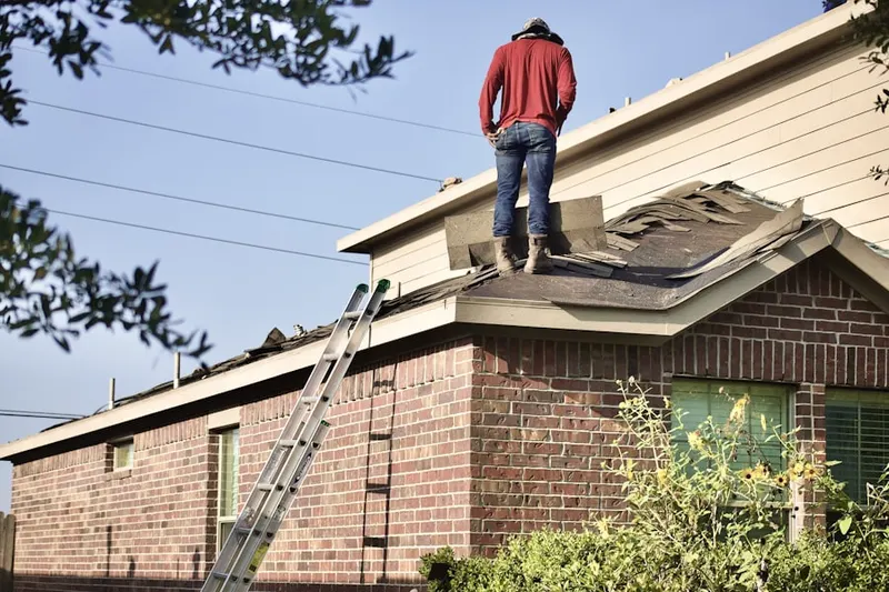 Professional roofer working on a residential roof in Raleigh